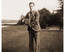 Black and white photo of Lord Egerton holding first camera